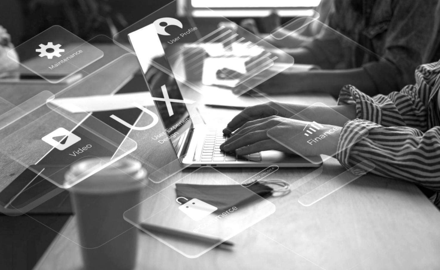 Student working on web development project with multiple monitors showing code and design interfaces